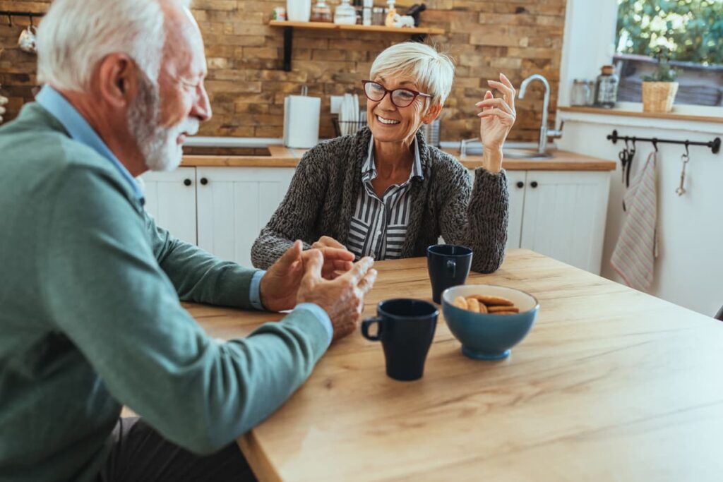Seniors discussing topics at a kitchen table