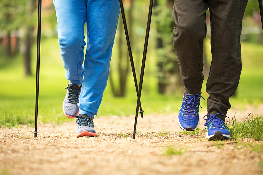 A close-up shot of the poles of a couple using Nordic walking poles.
