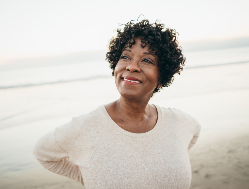 Woman on the beach smiling