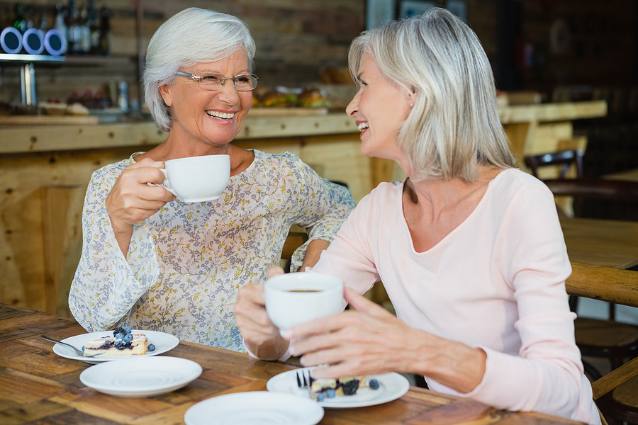 Two senior women meet for coffee.